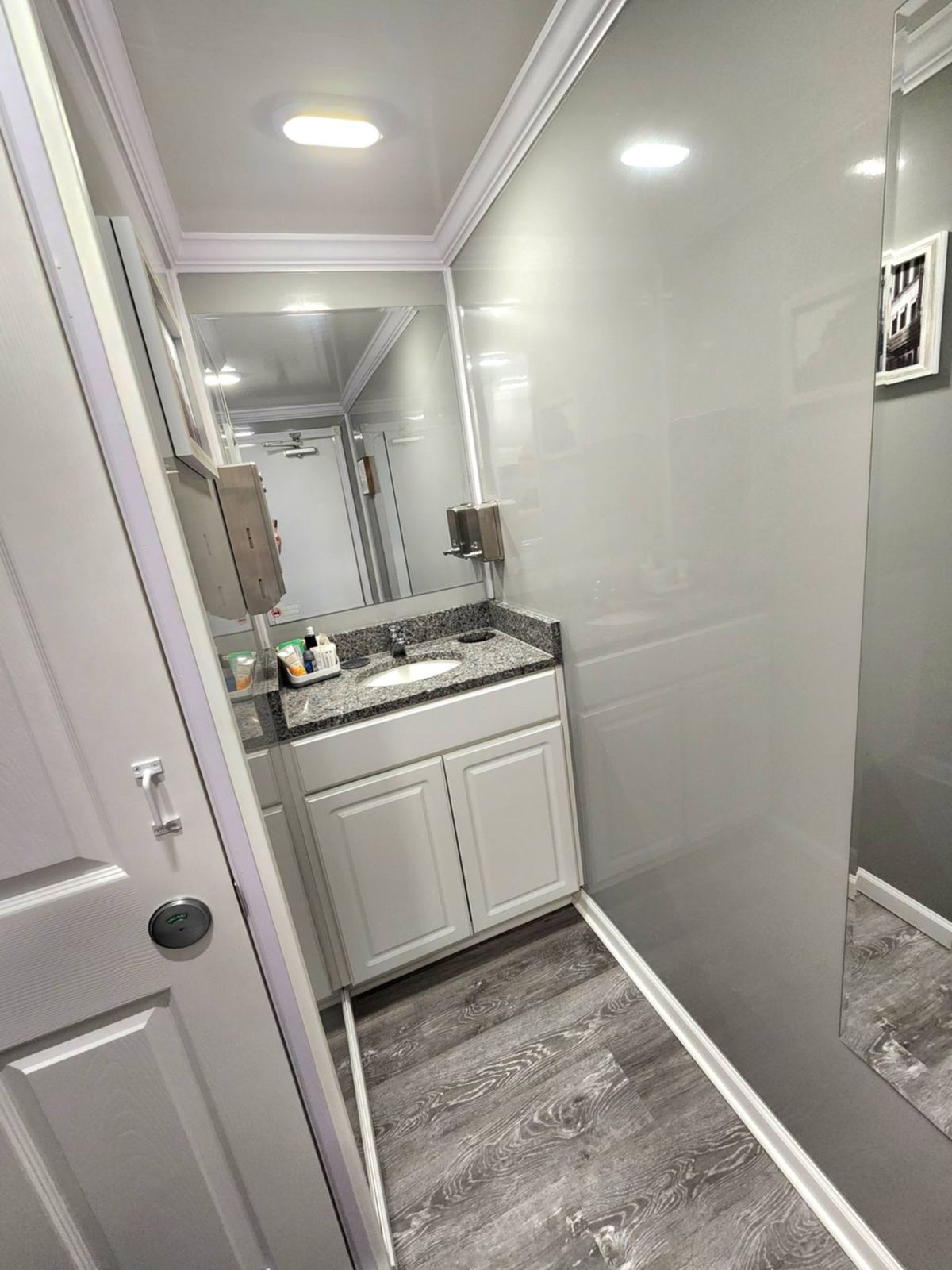 Interior restroom with urinal and framed art