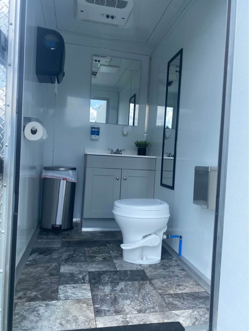 2-stall trailer interior with toilet and vanity